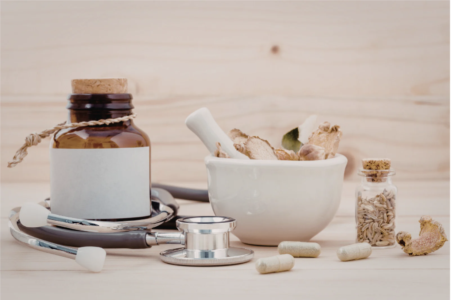 Traditional Chinese medicine herbs with mortar and pestle and stethoscope