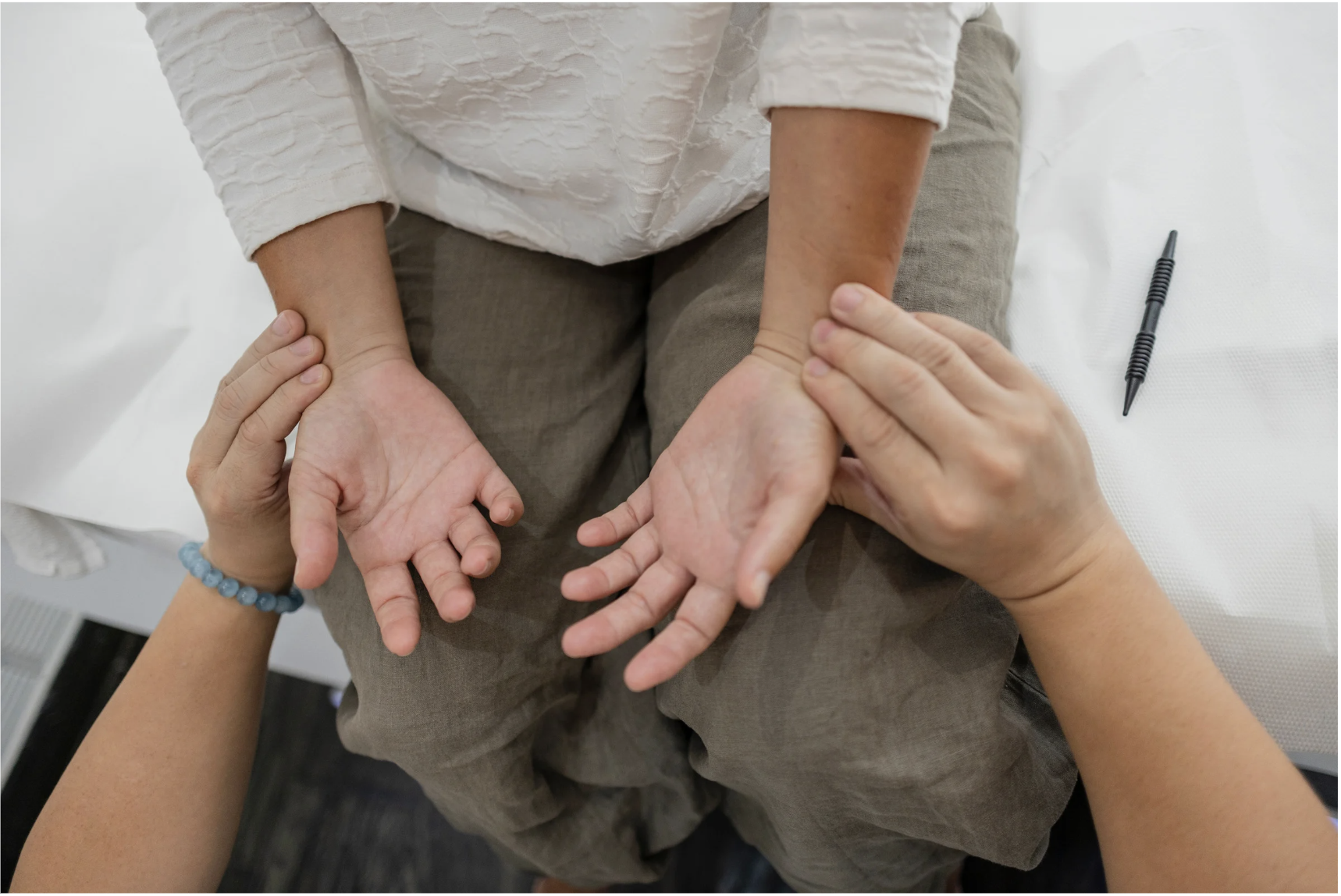 A TCM practitioner conducting pulse diagnosis — pattern identification is the foundation of all treatment