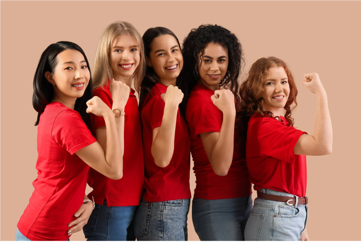 Group of diverse women in red shirts celebrating strength together